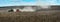 Terebovla region, Ternopil ,Ukraine - 14 September, 2019 : Panorama of the while sowing the field, tractor creates beautiful dust