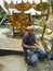 TERENGGANU, MALAYSIA -  SEPTEMBER 2019 : Unidentified kite maker Malay man uses small knife sharpen bamboo stick to make the kite