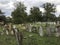 TERESVA, UKRAINE, SEPTEMBER 18, 2017; An old Jewish cemetery. Shattered gravestones stand among the green grass. On them - inscrip