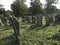 TERESVA, UKRAINE, SEPTEMBER 18, 2017; An old Jewish cemetery. Shattered gravestones stand among the green grass. On them - inscrip