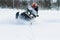 Teriberka, Russia - February 24, 2018: Man in a sports helmet rides a snowmobile