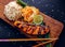 Teriyaki salmon with rice on a wooden platter