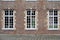 Ternat, Flemish Brabant Region, Belgium, Traditional brick stone wall with symmetrical windows of a school