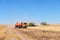 TERNOPIL - JULY 20: A few combines cutting a swath through the middle of a wheat field during harvest on July 20, 2017