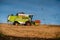 TERNOPIL REGION, UKRAINE - October 23, 2021 - old combine CLAAS harvester works in the field. harvesting soybeans