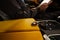 Ternopil, Ukraine- November 11, 2022:  Keys inside yellow Lamborghini Urus with driver
