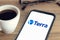 Terra Luna logo on Smart phone screen on desk with a cup of coffee