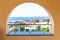 Terrace with arch overlooking the sea. A semicircular window overlooking the villa and tropical trees. Sea view from a luxury