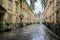 Terrace of Georgian houses with wet reflective flagstones in North Parade Buildings, Bath, Somerset, UK