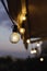 Terrace lights on at dusk hanging from an awning