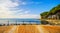 Terrace, promenade and pine trees in Bolsena lake, Italy.