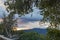 Terrace wall with garden foliage overlooking hillside and expansive sunset