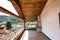 Terrace with wooden ceiling and tiles, landscape and hills