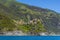 Terraced hillsides reach up from the Cinque Terre village of Corniglia, Italy