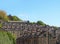 Terraced stone houses on a hillside surrounded by trees with a blue summer sky in hebden bridge west yorkshire