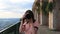 Terracina, Italy. Young Caucasian Woman Tourist Photograph Taking Photos Near Remains Of Temple Of Jupiter Anxur