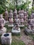 Terracotta army soldiers stand among the trees