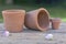 terracotta flowerpots put on wooden table in a garden