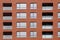 Terracotta modern facade of the house with windows and loggias