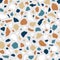 Terrazzo flooring texture with seamless repeatable pattern of small organic stone pieces. Abstract backdrop with