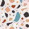 Terrazzo seamless pattern with motley stones. Abstract backdrop with colorful mineral rocks scattered on light