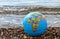 Terrestrial globe on a marine beach