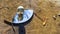 Terrestrial globe placed on an eye-shaped mirror, itself placed on the ground, in a puddle