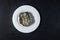 Terrible expired food covered with mold on white plate, top view. Dark background made of natural stone, copy space. Concept -