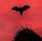 Terrible horrible bat silhouette in sky in flight