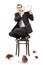 Terrified businessman standing on chair defending himself from r