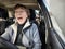 Terrified female driver a second before the accident. Scared middle-aged adult woman holds the steering wheel of a car