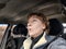 Terrified female driver a second before the accident. Scared middle-aged adult woman holds the steering wheel of a car