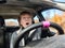 Terrified female driver a second before the accident. Scared middle-aged adult woman holds the steering wheel of a car