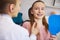 Terrified girl looking at female orthodontist