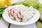 Terrine of curd and radish in plate on light board