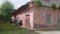 Territory of abandoned metallurgical plant with building of warehouse built with red brick.