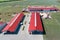 The territory of an industrial plant. Large hangars with a red roof.