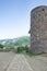 Territory of the Tatev Monastery. A tower, a stone road to the gate. Mountain View. Armenia.