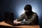 Terrorist working on his computer. Masked cyber terrorist hacking army intelligence