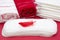 Terry bath towels, red feather on menstrual woman pad for blood period hygiene. Woman critical days, gynecological menstruation cy