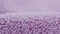 Terry lilac colored cloth towel texture as a background