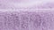 Terry lilac colored cloth towel texture as a background