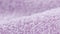 Terry lilac colored cloth towel texture as a background