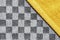 Terry yellow fabric lies diagonally on a black and white cage