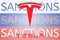 Tesla logo in front of the sanction text on the Russian flag. Fresh sanctions against Russia over its invasion of
