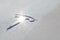 Tesla logo on the hood of a car with raindrops close up, electric car design. Tesla Motors electric car wet logo and sign