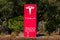 Tesla signpost with logo, sign at worldwide headquarters, Tesla, Inc. is an American electric vehicle and clean energy company -