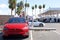 Tesla vehicles charging at super charging station next to gas station