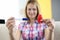 Test and red ribbon in hands of smiling woman closeup