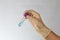 Test tube with blue transparent chemical fluid in the hands of a scientist. Hands in latex gloves. Vacuum test tube.